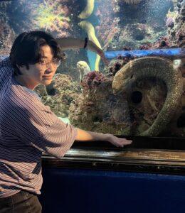 me forming a heart shape with a moray eel
