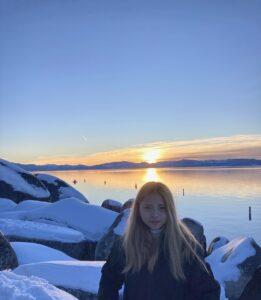 Phuc at Tahoe with sunset and lake pictured in the background.