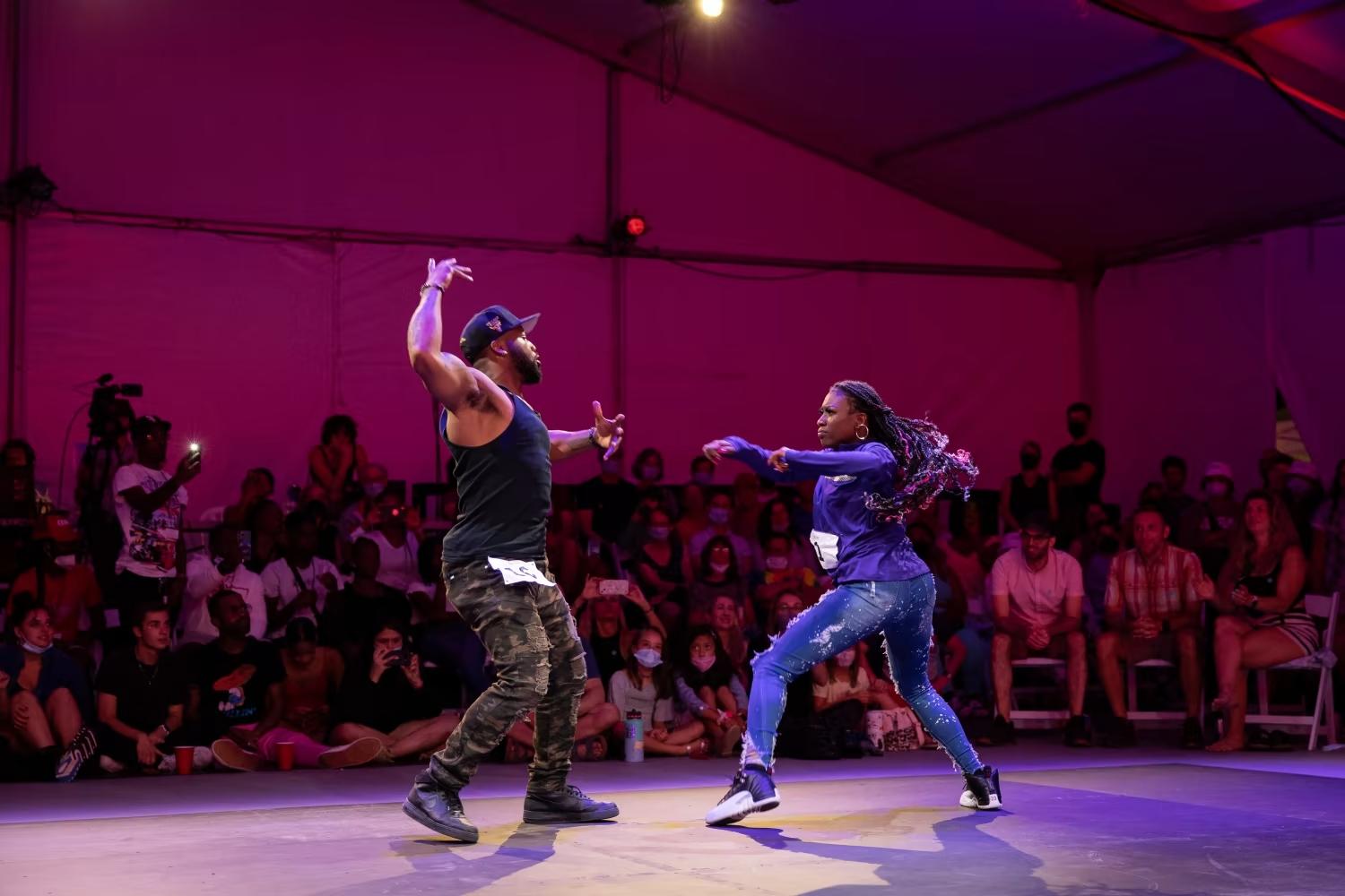 Two dancers in a dance battle against one another.