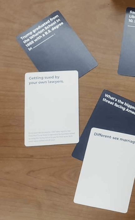 Cards from Trumped Up Cards. One pair is heterosexual marriage being the greatest threat to America. Another pair is getting sued by your own lawyers being what Trump graduated in. The lawyer card has very small text at the bottom explaining context.