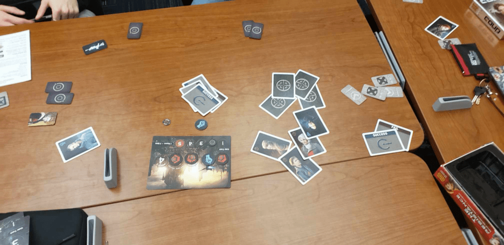 Cards/items from "The Resistance" on a table.